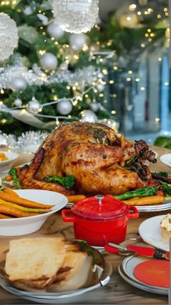 A beautifully roasted turkey on a Christmas dinner table